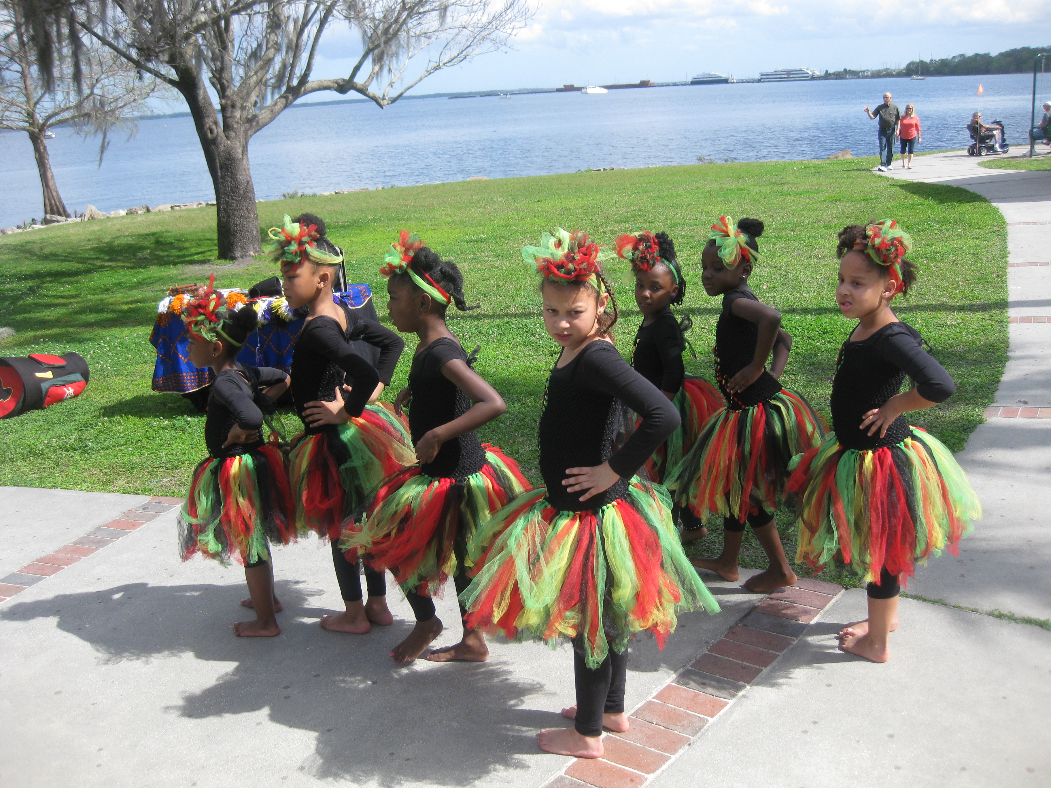 girls in red and green tutus preparing to dance